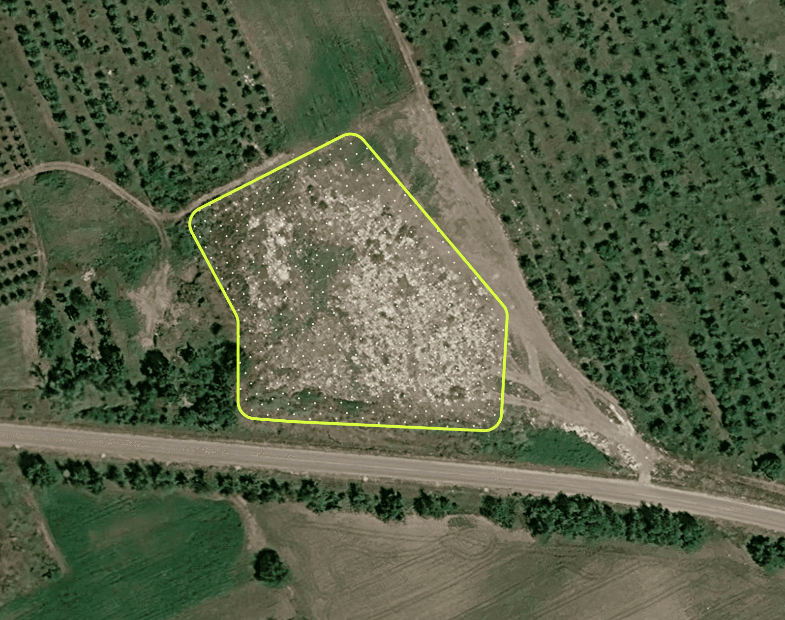 Satellite view of a landfill candidate beside a road in Moldova.